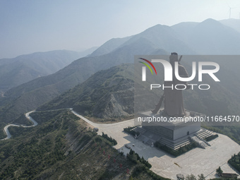 The statue of Guan Gong, the world's tallest saint, is seen under mist in Yuncheng, China, on October 14, 2024. (