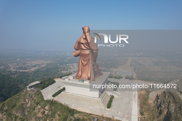 The statue of Guan Gong, the world's tallest saint, is seen under mist in Yuncheng, China, on October 14, 2024. 