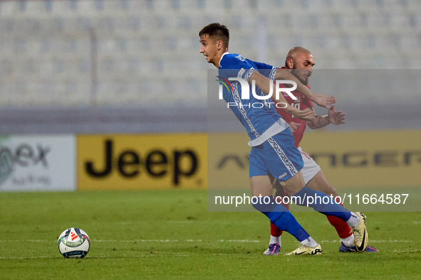 In Ta' Qali, Malta, on October 13, 2024, Mihail Caimacov of Moldova is challenged by Teddy Teuma of Malta during the UEFA Nations League, Le...