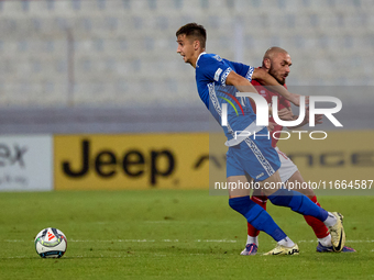 In Ta' Qali, Malta, on October 13, 2024, Mihail Caimacov of Moldova is challenged by Teddy Teuma of Malta during the UEFA Nations League, Le...