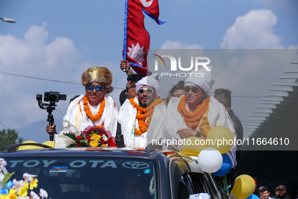 Record-setting climber Nirmal Purja, also known as Nimsdai, cheers as he arrives back in Kathmandu, Nepal, on October 14, 2024, after comple...