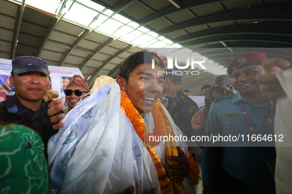 Nima Rinji Sherpa, 18, the youngest summiteer to have climbed all 14 of the world's peaks towering over 8000 meters, arrives at Tribhuvan In...