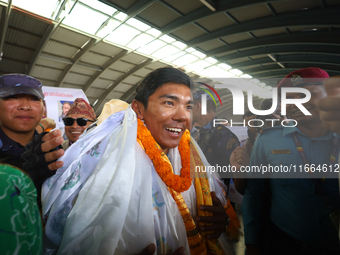 Nima Rinji Sherpa, 18, the youngest summiteer to have climbed all 14 of the world's peaks towering over 8000 meters, arrives at Tribhuvan In...