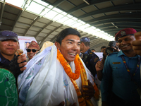 Nima Rinji Sherpa, 18, the youngest summiteer to have climbed all 14 of the world's peaks towering over 8000 meters, arrives at Tribhuvan In...