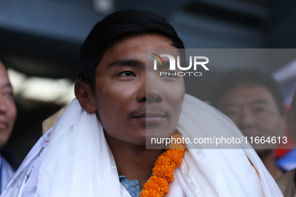 Nima Rinji Sherpa, 18, the youngest summiteer to have climbed all 14 of the world's peaks towering over 8000 meters, arrives at Tribhuvan In...