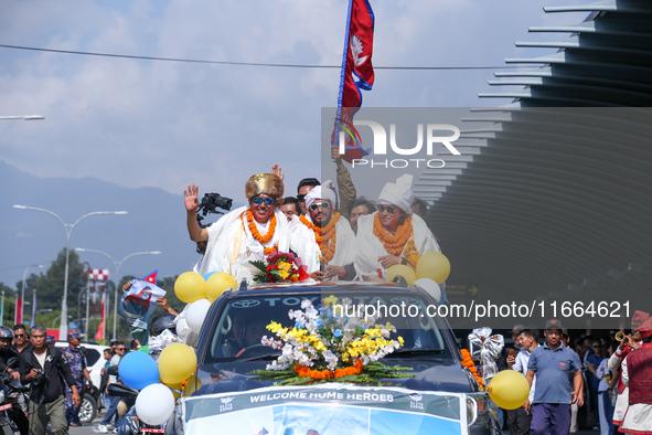 Record-setting climber Nirmal Purja, also known as Nimsdai, cheers as he arrives back in Kathmandu, Nepal, on October 14, 2024, after comple...