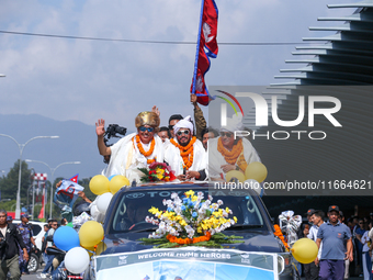 Record-setting climber Nirmal Purja, also known as Nimsdai, cheers as he arrives back in Kathmandu, Nepal, on October 14, 2024, after comple...