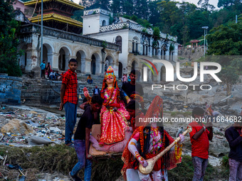 Hindu devotees immerse an idol of the Hindu goddess Durga into the Bagmati River in Kathmandu, Nepal, on October 14, 2024. In Hindu mytholog...