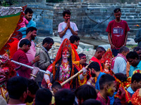 Hindu devotees immerse an idol of the Hindu goddess Durga into the Bagmati River in Kathmandu, Nepal, on October 14, 2024. In Hindu mytholog...