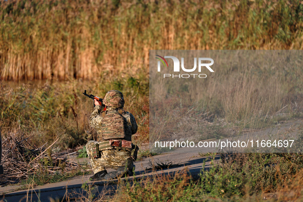 A serviceman of a mobile fire group of the State Border Guard Service of Ukraine aims a rifle while on a mission in Odesa region, Ukraine, o...