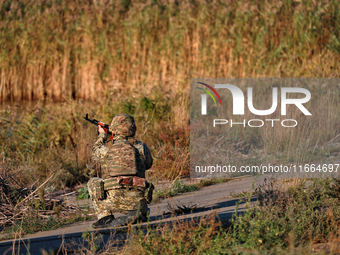 A serviceman of a mobile fire group of the State Border Guard Service of Ukraine aims a rifle while on a mission in Odesa region, Ukraine, o...