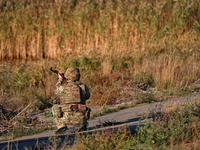 A serviceman of a mobile fire group of the State Border Guard Service of Ukraine aims a rifle while on a mission in Odesa region, Ukraine, o...