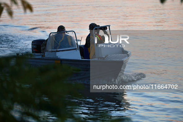 Servicemen of the State Border Guard Service of Ukraine swim in a boat while on patrol in Odesa region, southern Ukraine, on October 10, 202...