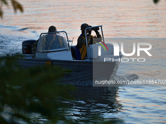 Servicemen of the State Border Guard Service of Ukraine swim in a boat while on patrol in Odesa region, southern Ukraine, on October 10, 202...