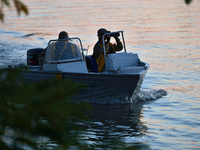 Servicemen of the State Border Guard Service of Ukraine swim in a boat while on patrol in Odesa region, southern Ukraine, on October 10, 202...