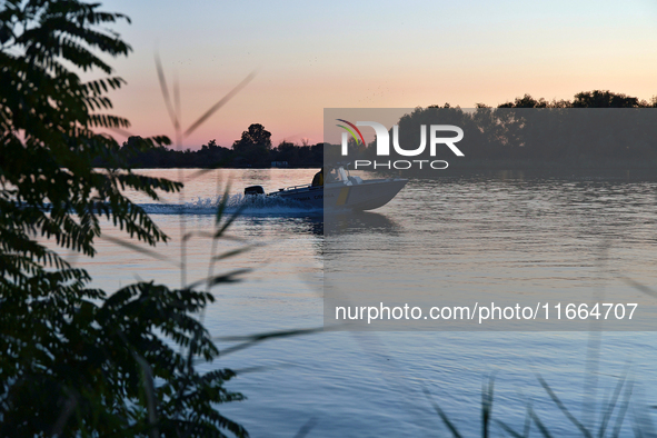 Servicemen of the State Border Guard Service of Ukraine swim in a boat while on patrol in Odesa region, southern Ukraine, on October 10, 202...