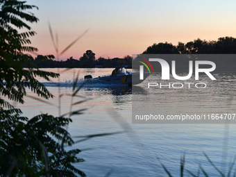 Servicemen of the State Border Guard Service of Ukraine swim in a boat while on patrol in Odesa region, southern Ukraine, on October 10, 202...