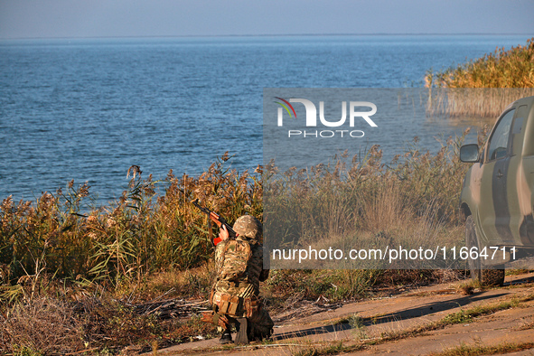 A serviceman of a mobile fire group of the State Border Guard Service of Ukraine aims a rifle while on a mission in Odesa region, Ukraine, o...