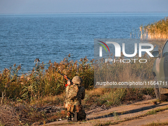 A serviceman of a mobile fire group of the State Border Guard Service of Ukraine aims a rifle while on a mission in Odesa region, Ukraine, o...