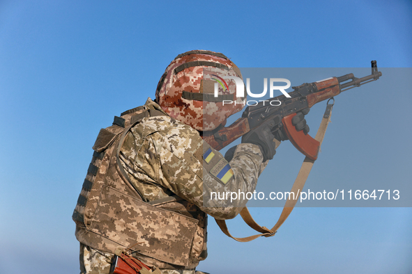 A serviceman of a mobile fire group of the State Border Guard Service of Ukraine aims a rifle while on a mission in Odesa region, Ukraine, o...