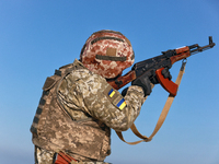 A serviceman of a mobile fire group of the State Border Guard Service of Ukraine aims a rifle while on a mission in Odesa region, Ukraine, o...