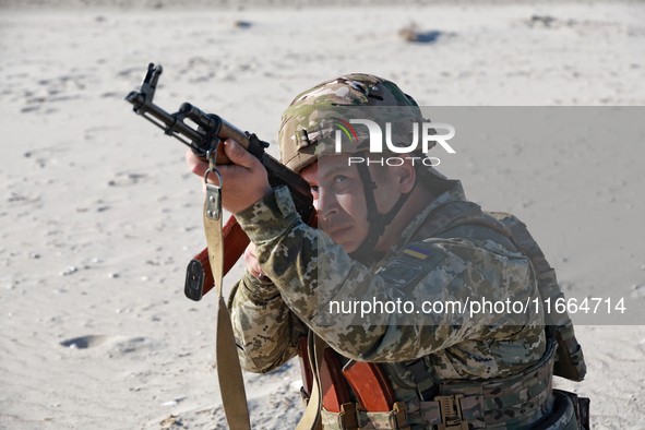 A serviceman of a mobile fire group of the State Border Guard Service of Ukraine aims a rifle while on a mission in Odesa region, Ukraine, o...