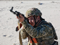 A serviceman of a mobile fire group of the State Border Guard Service of Ukraine aims a rifle while on a mission in Odesa region, Ukraine, o...