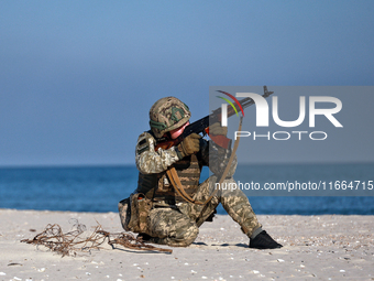 A serviceman of a mobile fire group of the State Border Guard Service of Ukraine aims a rifle while on a mission in Odesa region, Ukraine, o...