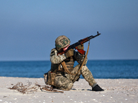 A serviceman of a mobile fire group of the State Border Guard Service of Ukraine aims a rifle while on a mission in Odesa region, Ukraine, o...