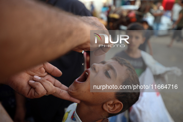 Palestinian children receive drops as part of a polio vaccination campaign in Deir al-Balah, Gaza Strip, on October 14, 2024, amid the ongoi...