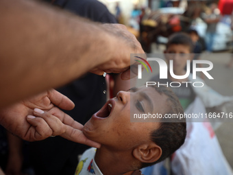 Palestinian children receive drops as part of a polio vaccination campaign in Deir al-Balah, Gaza Strip, on October 14, 2024, amid the ongoi...