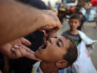 Palestinian children receive drops as part of a polio vaccination campaign in Deir al-Balah, Gaza Strip, on October 14, 2024, amid the ongoi...