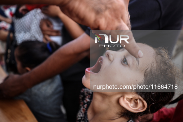 Palestinian children receive drops as part of a polio vaccination campaign in Deir al-Balah, Gaza Strip, on October 14, 2024, amid the ongoi...