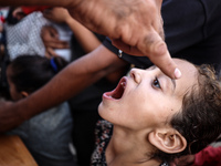 Palestinian children receive drops as part of a polio vaccination campaign in Deir al-Balah, Gaza Strip, on October 14, 2024, amid the ongoi...