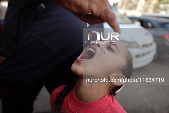 Palestinian children receive drops as part of a polio vaccination campaign in Deir al-Balah, Gaza Strip, on October 14, 2024, amid the ongoi...