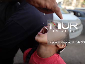 Palestinian children receive drops as part of a polio vaccination campaign in Deir al-Balah, Gaza Strip, on October 14, 2024, amid the ongoi...