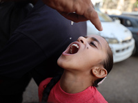 Palestinian children receive drops as part of a polio vaccination campaign in Deir al-Balah, Gaza Strip, on October 14, 2024, amid the ongoi...