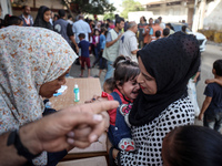 Palestinian children receive drops as part of a polio vaccination campaign in Deir al-Balah, Gaza Strip, on October 14, 2024, amid the ongoi...