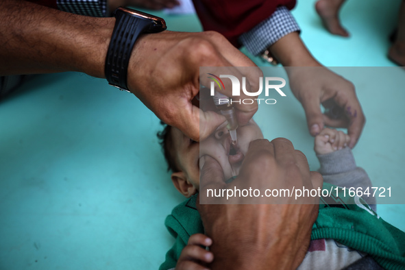 Palestinian children receive drops as part of a polio vaccination campaign in Deir al-Balah, Gaza Strip, on October 14, 2024, amid the ongoi...