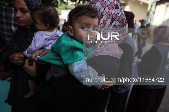 Palestinian children receive drops as part of a polio vaccination campaign in Deir al-Balah, Gaza Strip, on October 14, 2024, amid the ongoi...