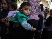 Palestinian children receive drops as part of a polio vaccination campaign in Deir al-Balah, Gaza Strip, on October 14, 2024, amid the ongoi...