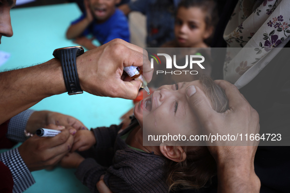 Palestinian children receive drops as part of a polio vaccination campaign in Deir al-Balah, Gaza Strip, on October 14, 2024, amid the ongoi...