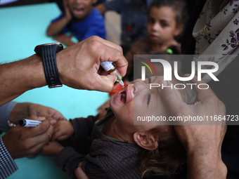 Palestinian children receive drops as part of a polio vaccination campaign in Deir al-Balah, Gaza Strip, on October 14, 2024, amid the ongoi...