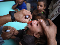 Palestinian children receive drops as part of a polio vaccination campaign in Deir al-Balah, Gaza Strip, on October 14, 2024, amid the ongoi...