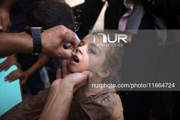 Palestinian children receive drops as part of a polio vaccination campaign in Deir al-Balah, Gaza Strip, on October 14, 2024, amid the ongoi...