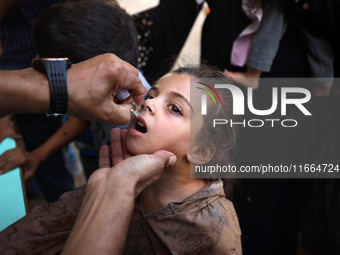 Palestinian children receive drops as part of a polio vaccination campaign in Deir al-Balah, Gaza Strip, on October 14, 2024, amid the ongoi...