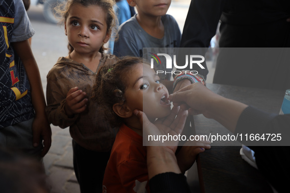 Palestinian children receive drops as part of a polio vaccination campaign in Deir al-Balah, Gaza Strip, on October 14, 2024, amid the ongoi...