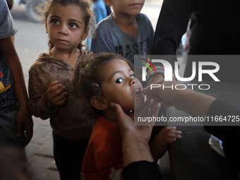 Palestinian children receive drops as part of a polio vaccination campaign in Deir al-Balah, Gaza Strip, on October 14, 2024, amid the ongoi...