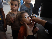 Palestinian children receive drops as part of a polio vaccination campaign in Deir al-Balah, Gaza Strip, on October 14, 2024, amid the ongoi...