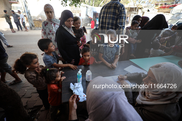 Palestinian children receive drops as part of a polio vaccination campaign in Deir al-Balah, Gaza Strip, on October 14, 2024, amid the ongoi...